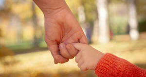 parent holding child hand